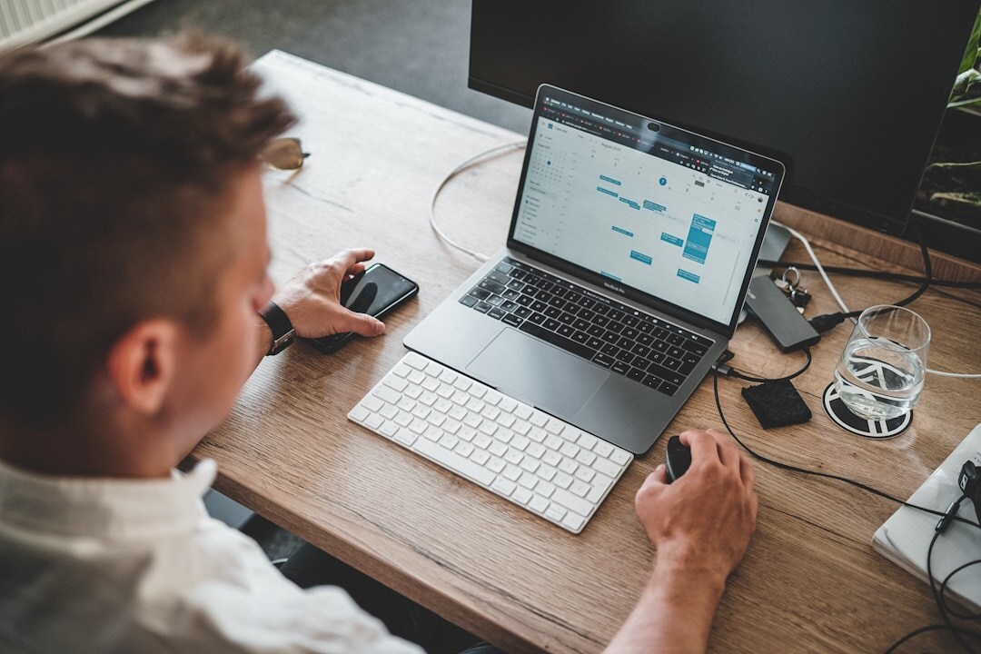 young adult creating budget on laptop