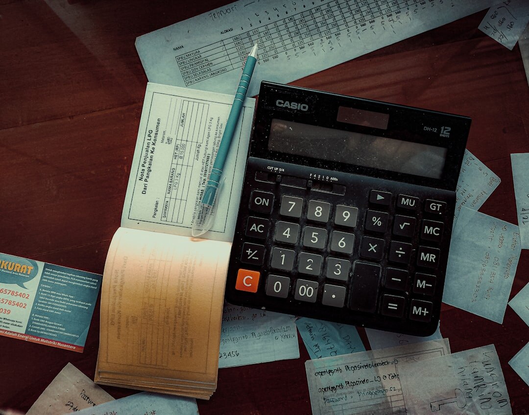 Personal finance planning with documents and calculator on desk