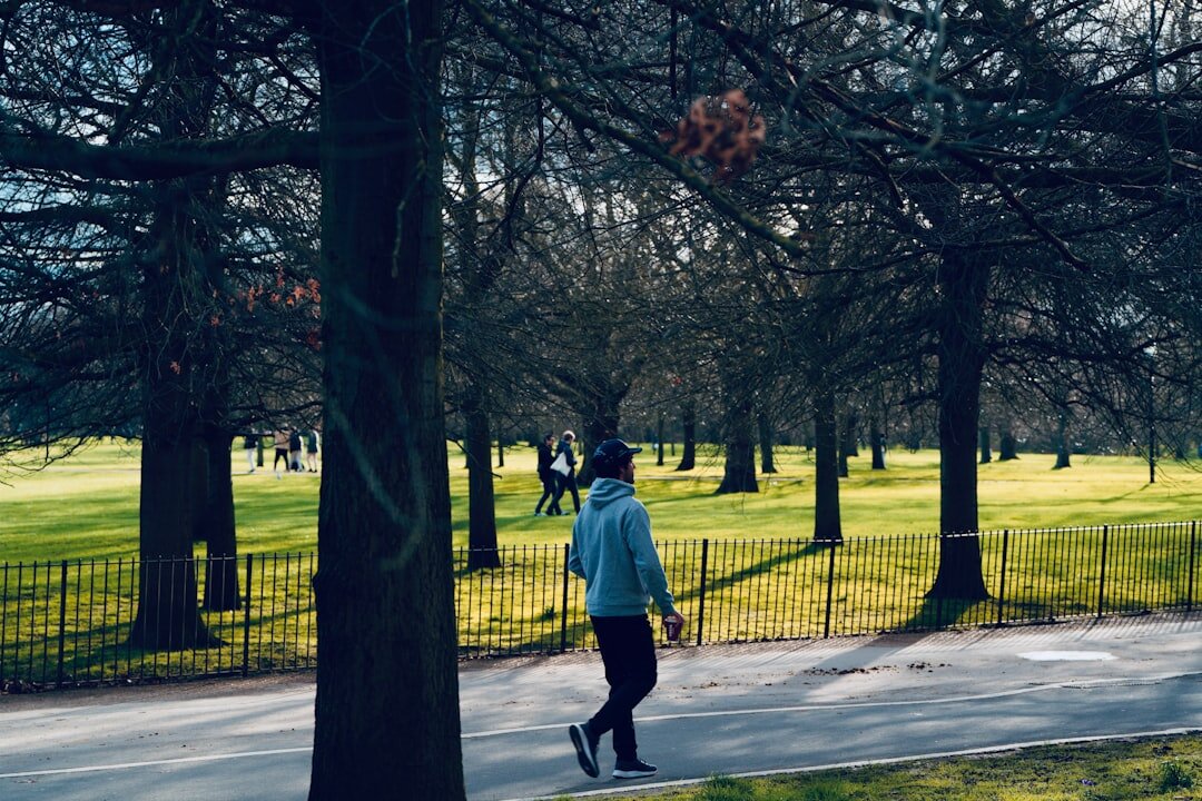 person walking in park after work